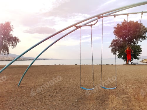 Preview: Girl on swings at a park