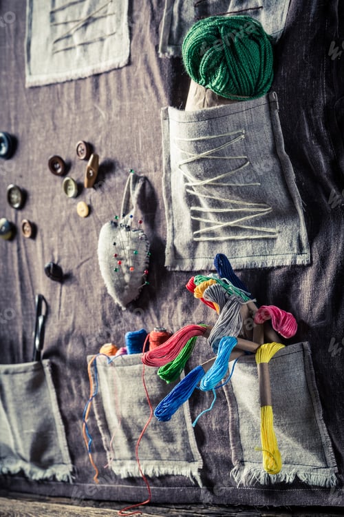 Preview: Sewing mat with threads, scissors and buttons in sewing workshop