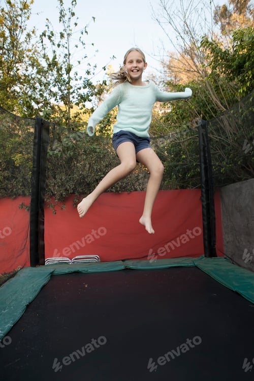 Preview: Girl having fun on garden trampoline