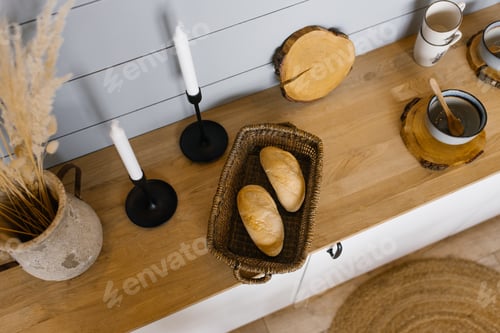 Preview: Two French bread rolls in a wicker basket on the Scandinavian-style kitchen countertop