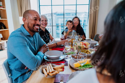 Preview: Family and friends reunion at home. Multi-generational family gathering having lunch at home