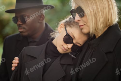 Preview: Mother and daughter embracing at funeral