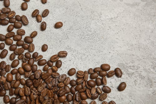 Preview: Pile of Aromatic Roasted Coffee Beans on Gray Surface