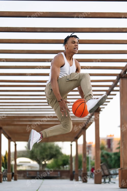 Preview: Multiracial person posing with basketball ball