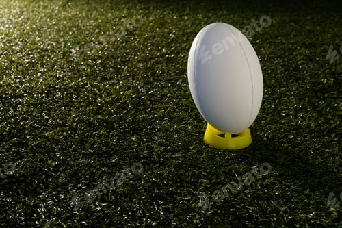 Preview: White rugby ball over grass with copy space, in slow motion
