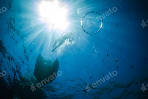 Preview: Unrecognizable boy snorkeling in blue sea under bright sunlight