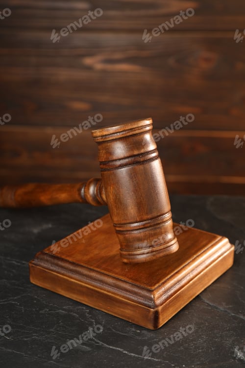 Preview: Wooden gavel and sound block on dark textured table, closeup