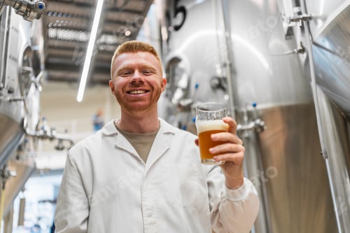 Preview: Brewmaster holding craft beer in brewery