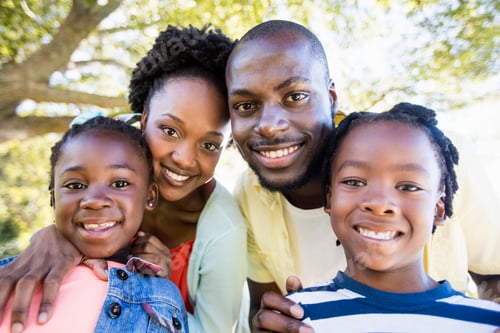 Preview: Smiling Family Together in a Green Park