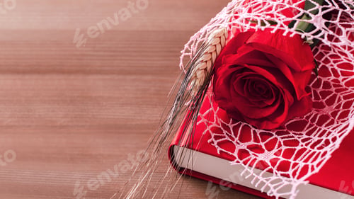 Preview: Red rose and red book on wooden background, Sant Jordi holiday card
