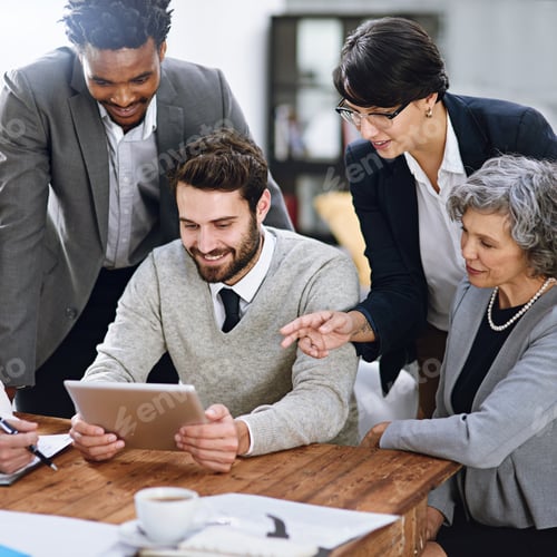Preview: Cropped shot of a group of businesspeople working together on a digital tablet in an office