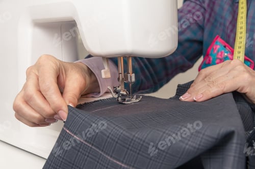 Preview: Seamstress hands working on a sewing machine