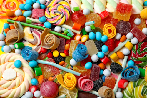 Preview: Many different yummy candies as background, top view