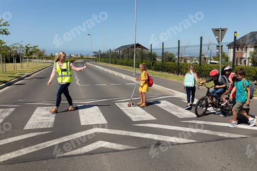 Preview: Woman wearing a high visibility vest on a pedestrian crossing
