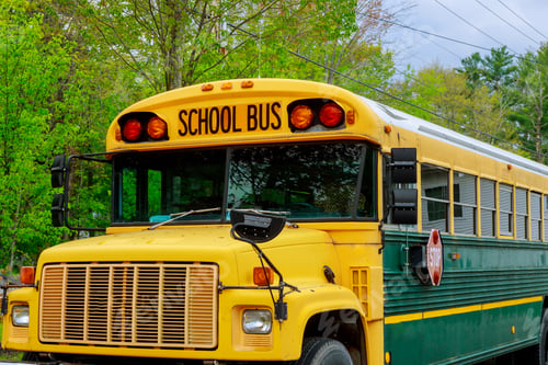 Preview: Close up front part of yellow school bus children educational transport with signs in the parking