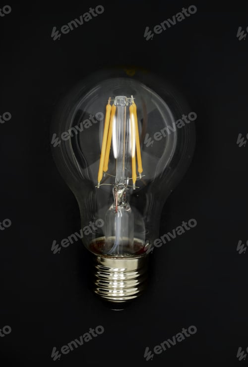 Preview: Single light bulb on black background