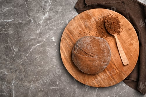 Preview: Flat lay composition with fresh dough and cocoa powder on table