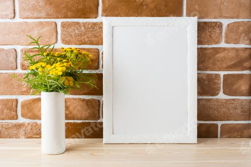 Preview: White frame mockup with yellow flowers near exposed brick walls