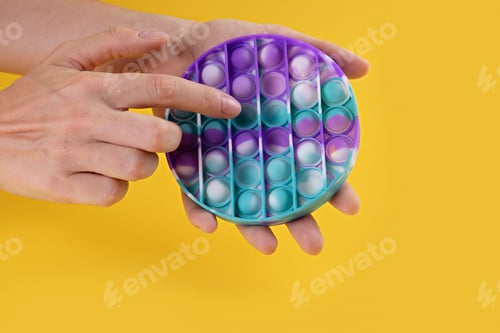 Preview: Female hans using pastel color round popit toy antistress