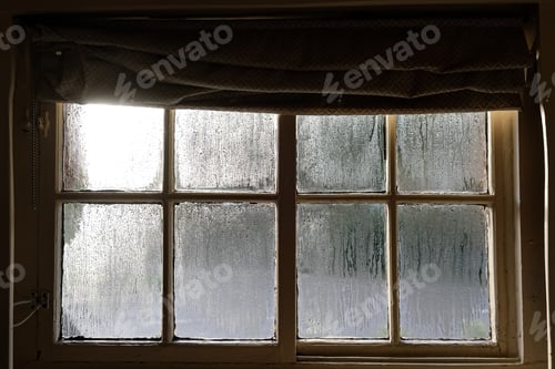 Preview: Old vintage medieval window view, with wooden frame, glass covered with drops, rain outside, rainy d