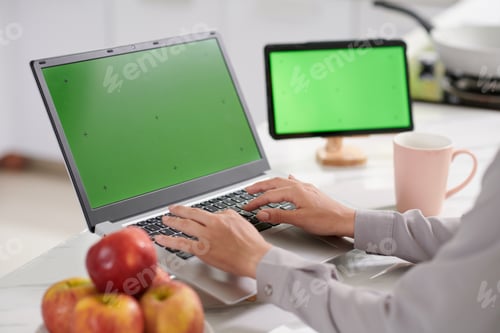 Preview: Hands of young woman typing on keypad of laptop while creating new application