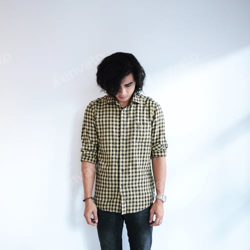 Preview: Young Man in Plaid Shirt Looking Down