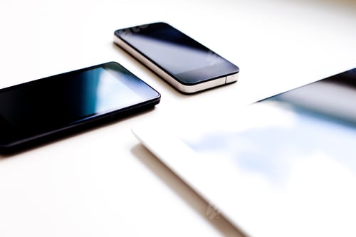Preview: High angle view of smart phones and digital tablet on white background