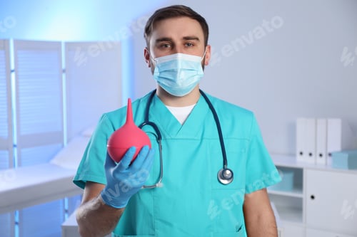 Preview: Doctor holding rubber enema in examination room