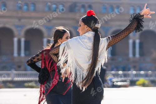 Preview: Back of two woman dancing flamenco outdoors