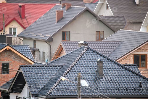 Preview: Residential houses with roof tops covered with metallic and ceramic shingles in rural suburban area