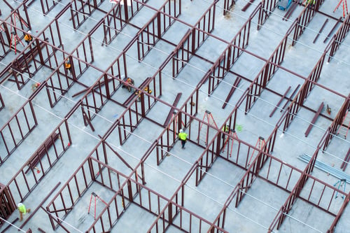 Preview: Construction works on metal walls of commercial building.