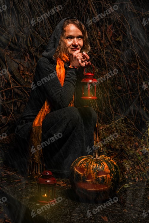 Preview: Happy Halloween! A pretty witch with a big pumpkin. Beautiful young in a witch costume