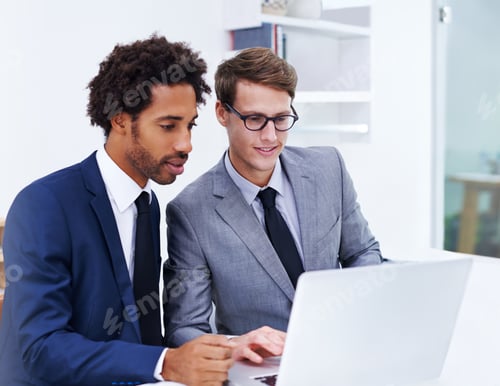 Preview: Shot of two male colleagues working together on a laptop
