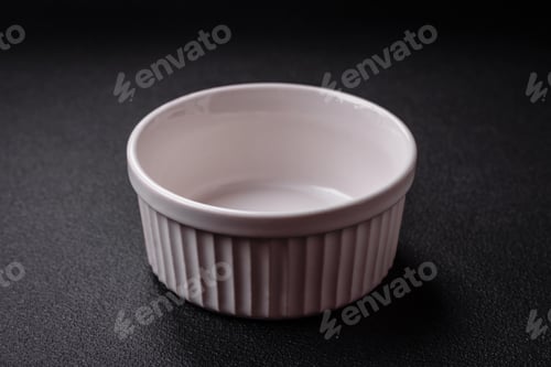 Preview: Beautiful empty white ceramic gravy boat on a textured concrete background