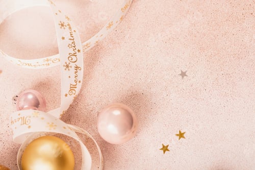 Preview: Festive Christmas and New Year background with gold and pink baubles and ribbons