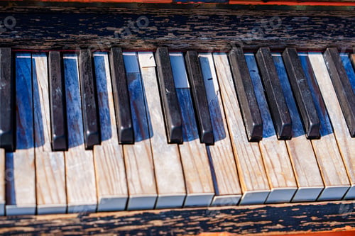 Preview: Piano keys close up of old vintage retro piano with peeling white ivory keys and black ebony keys