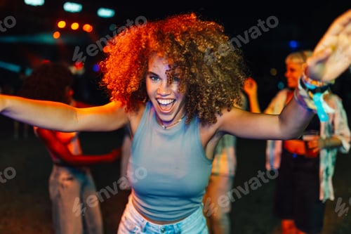 Preview: Young woman dancing and enjoying live music at night concert