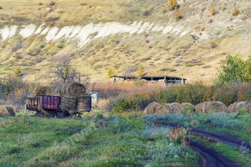 Preview: Haystacks at the foot of the chalk mountains piled on a cart