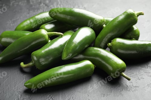 Preview: Fresh jalapeno peppers on black textured table, closeup