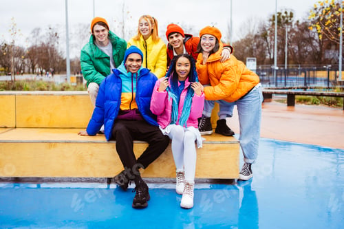 Preview: Multiracial group of young friends meeting outdoors in winter