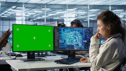 Preview: Employee works on green screen computer in server hub, using AI to process data
