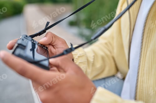 Preview: Photographer in beige clothes checking the shots