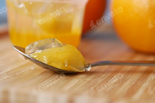Preview: colorful orange flavor jelly on plate on table,
