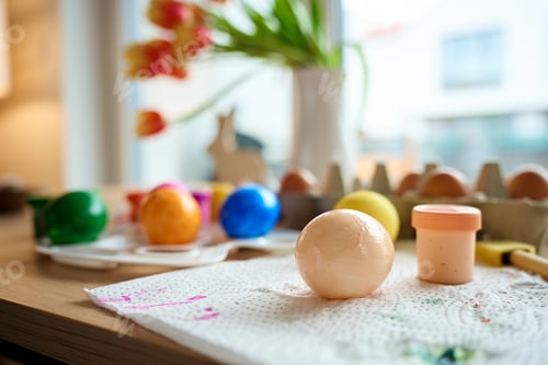 Preview: Painted Easter eggs with paints and palette on wooden table