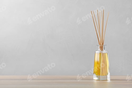 Preview: Reed air freshener on wooden table against grey background, space for text