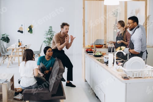 Preview: Friends cooking dinner together enjoying communication at home