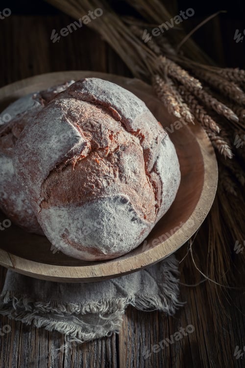 Preview: Brown loaf of bread in dark kitchen