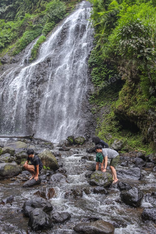 Preview: Three Joyful Friends Enjoying And Refreshing Adventure While Explore Lush Jungle Waterfall