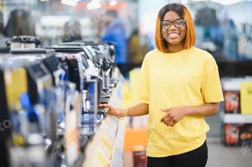 Preview: Smart modern african american female customer choosing coffee machine at electronics store