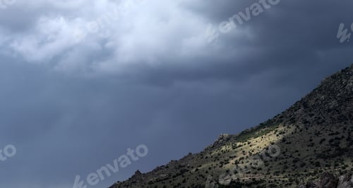 Preview: light and shadow falling from dramatic sky onto mountainside